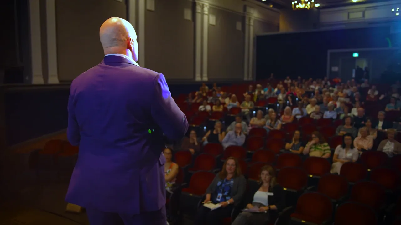 Stephen facing the audience from the stage